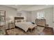 Cozy bedroom featuring a wicker headboard, modern light fixture, and neutral decor at 4410 Miller Way, Westfield, IN 46062
