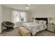 Bedroom with a large window, bed, round papasan chair, and neutral carpet at 4410 Miller Way, Westfield, IN 46062