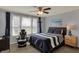 Cozy bedroom with natural light, gaming chair, ceiling fan and comfortable bed, creating a relaxing retreat at 4410 Miller Way, Westfield, IN 46062