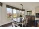 Bright dining room with a large table, white chairs, a buffet, hardwood floors, and a large window at 4410 Miller Way, Westfield, IN 46062