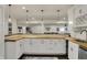 Bright view of a kitchen with white cabinets, wood countertops, pendant lights, and stainless appliances at 4410 Miller Way, Westfield, IN 46062