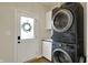 Laundry room showcasing a stacked washer and dryer, utility sink, and convenient access to the outside at 4410 Miller Way, Westfield, IN 46062