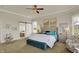 Inviting main bedroom with a tufted headboard, a ceiling fan, neutral tones, and ensuite bathroom at 4410 Miller Way, Westfield, IN 46062