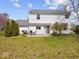 View of the back exterior featuring a patio with furniture, a grill, and a large grassy yard at 45 Wisteria Way, Westfield, IN 46074