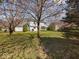 Expansive backyard with mature trees and a glimpse of the home's back exterior at 45 Wisteria Way, Westfield, IN 46074