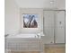 Bathroom features a soaking tub, a separate shower, and a large window with a view at 45 Wisteria Way, Westfield, IN 46074