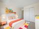 Cheerful bedroom featuring colorful accents, a playful bookshelf, and comfortable furnishings at 45 Wisteria Way, Westfield, IN 46074