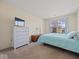 Bright bedroom featuring neutral walls, cozy carpet, and a large window offering natural light at 45 Wisteria Way, Westfield, IN 46074