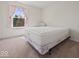 Simple bedroom design with neutral walls, carpet, and a window for natural lighting at 45 Wisteria Way, Westfield, IN 46074
