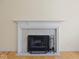 Elegant white fireplace with a decorative mantel and black iron screen at 45 Wisteria Way, Westfield, IN 46074