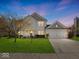 Charming two-story home with a well-manicured lawn, attached two-car garage and inviting curb appeal at 45 Wisteria Way, Westfield, IN 46074