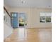 Bright living room featuring hardwood floors, a chandelier, and a blue entry door at 45 Wisteria Way, Westfield, IN 46074