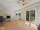 Open living space with a ceiling fan, fireplace, and sliding glass doors to the backyard at 45 Wisteria Way, Westfield, IN 46074