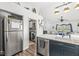 Updated kitchen view to stainless refrigerator, the laundry room and the living room at 47 Thornburg Pkwy, Brownsburg, IN 46112