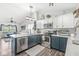 Open kitchen with stainless appliances, white subway tile, modern cabinets and a view of the living room at 47 Thornburg Pkwy, Brownsburg, IN 46112