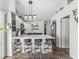 Bright kitchen features quartz countertops, modern lighting, and four bar stools at the breakfast bar at 47 Thornburg Pkwy, Brownsburg, IN 46112