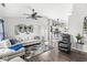 Bright living room featuring hardwood floors, a ceiling fan, and stylish decor; open to the kitchen at 47 Thornburg Pkwy, Brownsburg, IN 46112