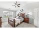 Primary bedroom featuring a ceiling fan, a large window, and wood furniture on carpet at 47 Thornburg Pkwy, Brownsburg, IN 46112