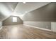 Spacious attic or bonus room featuring a window and light grey walls with wood-look floors at 4786 N Mill Ct, Greenfield, IN 46140
