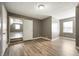 Bedroom with doorways to two additional rooms, and wood-look laminate flooring at 4786 N Mill Ct, Greenfield, IN 46140