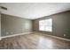 Bright, empty bedroom with modern vinyl floors and a large window at 4786 N Mill Ct, Greenfield, IN 46140