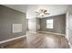 Bedroom with ceiling fan, window, and wood-look laminate flooring at 4786 N Mill Ct, Greenfield, IN 46140