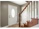 Interior view of the foyer featuring the front door and the wooden staircase at 4786 N Mill Ct, Greenfield, IN 46140