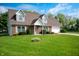 Lovely brick house with green lawn, blue skies, and a two-car garage on a sunny day at 4786 N Mill Ct, Greenfield, IN 46140