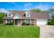Charming brick home with a well-manicured lawn, attached garage, and inviting front entrance at 4786 N Mill Ct, Greenfield, IN 46140