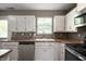 Bright kitchen with white cabinets, laminate counters, and stainless steel appliances at 4786 N Mill Ct, Greenfield, IN 46140