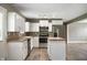 Well-lit kitchen featuring stainless steel appliances, white cabinets, and an island at 4786 N Mill Ct, Greenfield, IN 46140