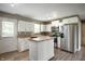Fully equipped kitchen featuring stainless steel appliances, white cabinetry, and a center island at 4786 N Mill Ct, Greenfield, IN 46140