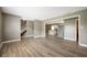 Spacious living room with modern vinyl floors, connecting to the kitchen and the staircase at 4786 N Mill Ct, Greenfield, IN 46140