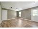Open living area with a white painted door and a window, featuring wood-look floors at 4786 N Mill Ct, Greenfield, IN 46140