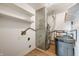 Utility room featuring a water softener, shelves, and wood-look floors at 4786 N Mill Ct, Greenfield, IN 46140