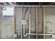 Unfinished basement shows interior wall construction, plumbing, and a glass block window at 507 Dr Martin Luther King Jr Blvd, Anderson, IN 46016