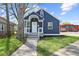 Charming blue home featuring a cozy front porch with white railing and inviting curb appeal at 507 Dr Martin Luther King Jr Blvd, Anderson, IN 46016