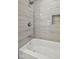 Walk-in shower featuring grey wood-look tile and a built-in niche at 507 Dr Martin Luther King Jr Blvd, Anderson, IN 46016