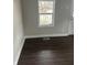 Bright living room with fresh paint, new floor and a large window at 517 W 26Th St, Indianapolis, IN 46208