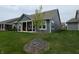 Spacious backyard with a covered patio, lush green lawn, and an attractive small tree at 5269 Parkhurst Xing, McCordsville, IN 46055