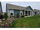 Inviting backyard featuring a covered patio, lush lawn, and landscaping that complements the home's exterior at 5269 Parkhurst Xing, McCordsville, IN 46055