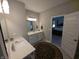 Well-lit bathroom with a vanity, mirror, and an open doorway to the main bedroom at 5269 Parkhurst Xing, McCordsville, IN 46055