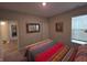 Comfortable bedroom with colorful bedding, a bright window and a framed mirror on the wall at 5269 Parkhurst Xing, McCordsville, IN 46055