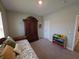 Charming bedroom featuring a decorative daybed and ample storage with a wooden armoire at 5269 Parkhurst Xing, McCordsville, IN 46055