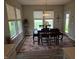 This bright dining room features large windows and a modern chandelier at 5269 Parkhurst Xing, McCordsville, IN 46055