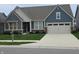 Inviting home showcasing a blue exterior, neatly kept lawn with a mailbox, and a convenient two-car garage at 5269 Parkhurst Xing, McCordsville, IN 46055