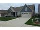 Attractive home with blue siding, well-maintained lawn, and an attached garage, exuding curb appeal at 5269 Parkhurst Xing, McCordsville, IN 46055