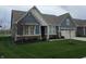 Delightful home featuring a blue exterior, verdant lawn, and an attached two-car garage for modern living at 5269 Parkhurst Xing, McCordsville, IN 46055