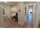 Hallway with wood flooring features a built-in desk, cabinet, and a view to the bedroom at 5269 Parkhurst Xing, McCordsville, IN 46055