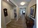 Hallway that leads into other rooms with wood flooring and decor at 5269 Parkhurst Xing, McCordsville, IN 46055